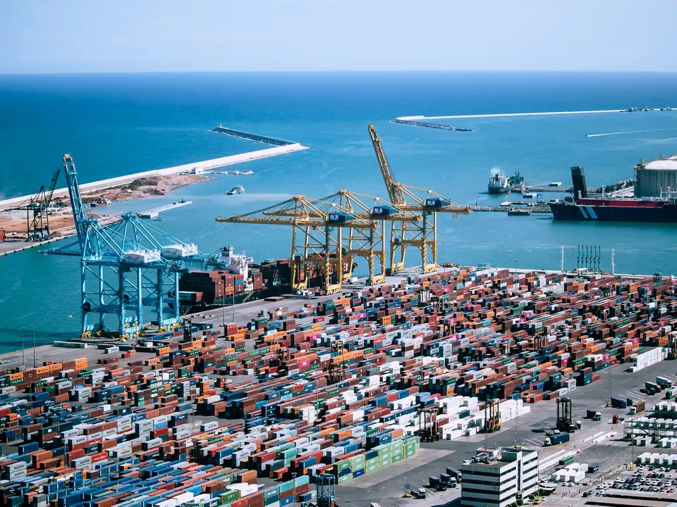 Aerial view of stacked shipping containers at a port terminal