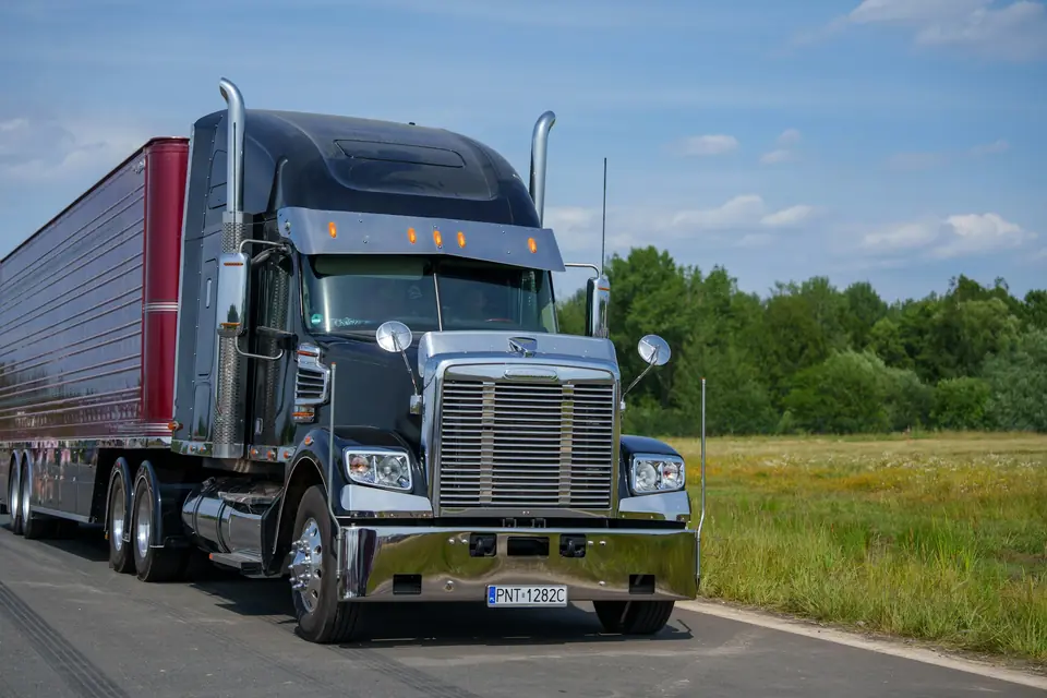 Truck on an open highway under a blue sky